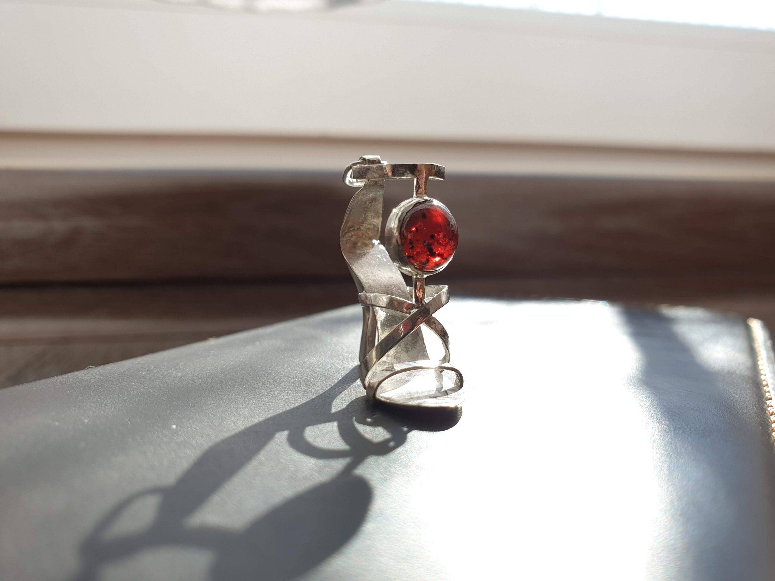 Strappy high heeled pendant with garnet cabochon
